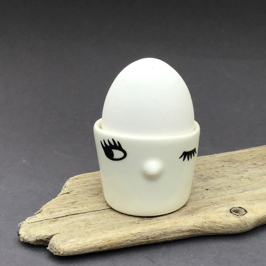 Nosy egg cup, one open eye.