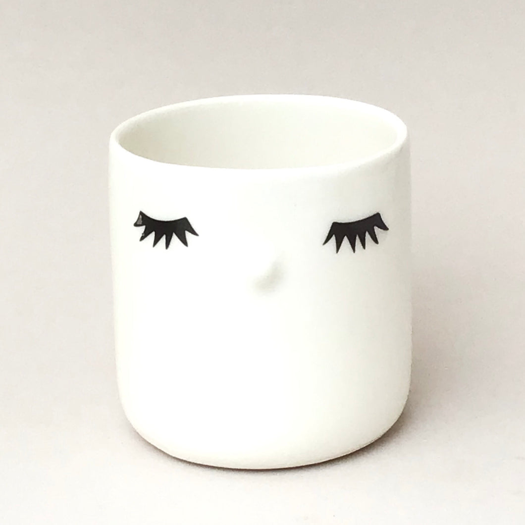 Nosy mug, closed eyes.