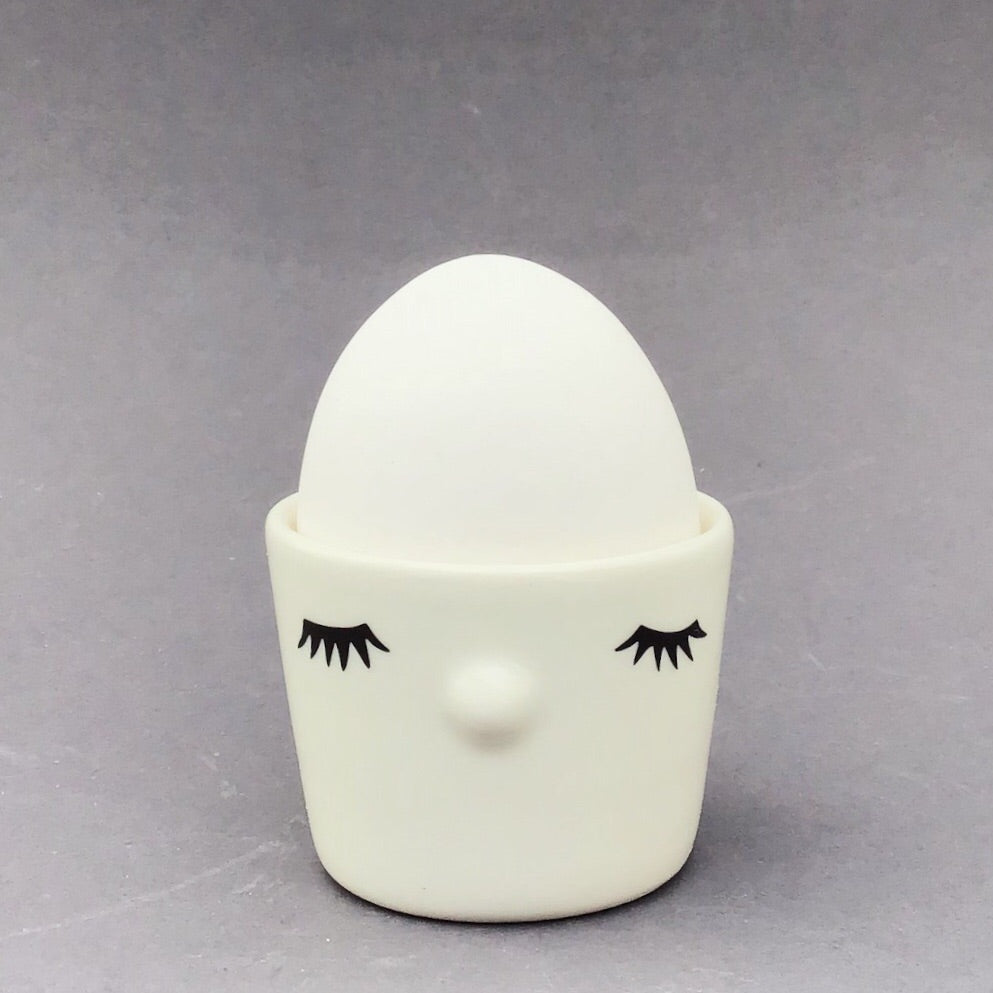 Nosy egg cup, closed eyes,